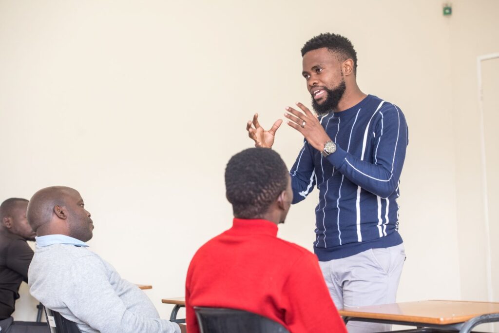 Lecturer Fakudze teaching students in classroom of education centre